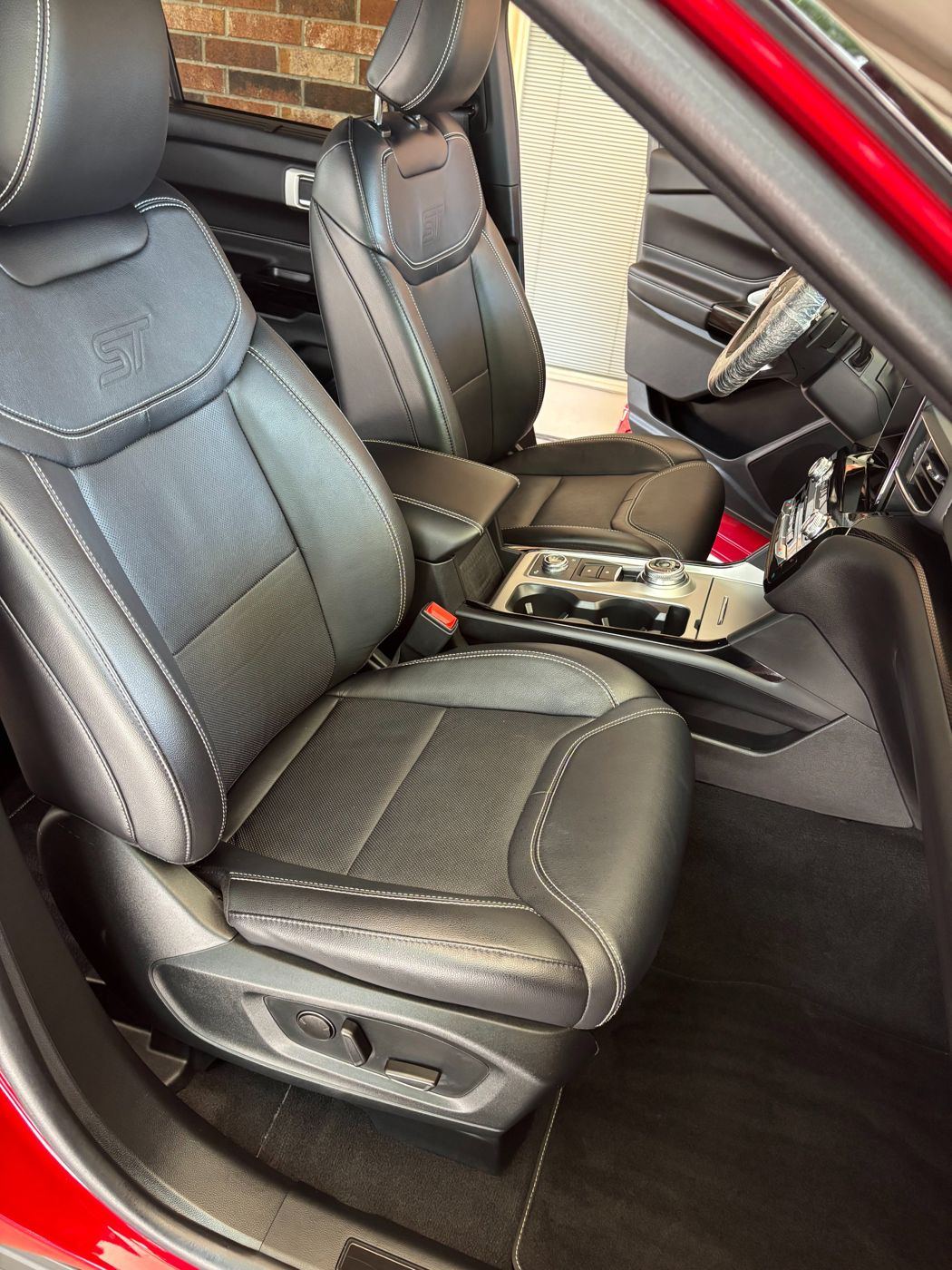 Clean black leather front seats and console in a Ford Explorer ST