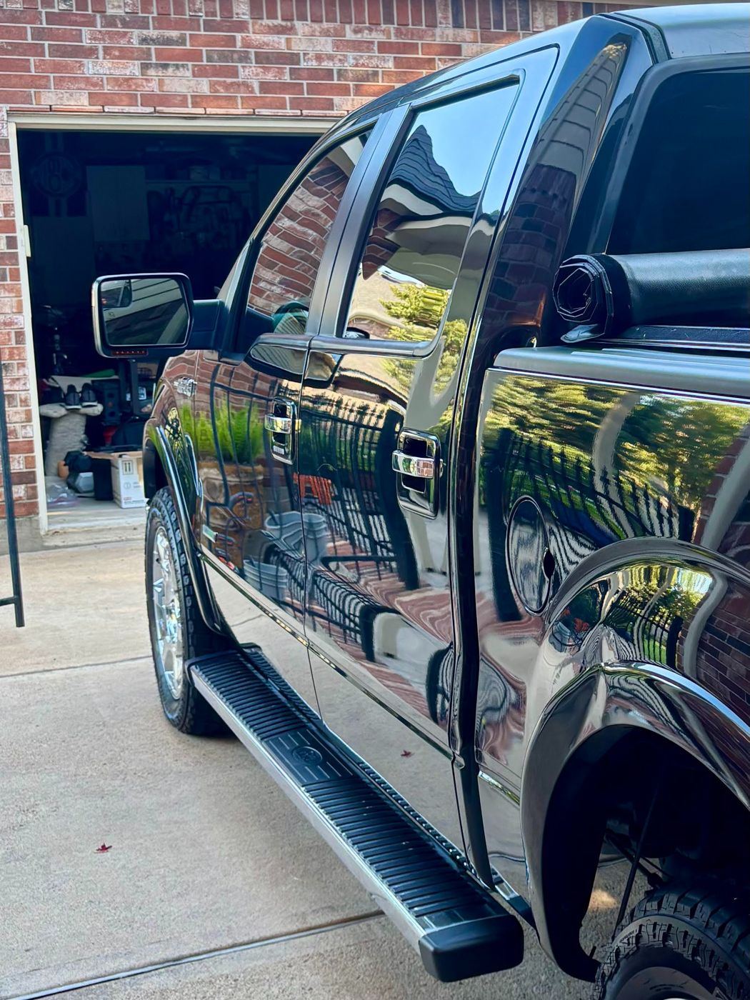 Mirror-like reflections on the side of a detailed black Ford F-150
