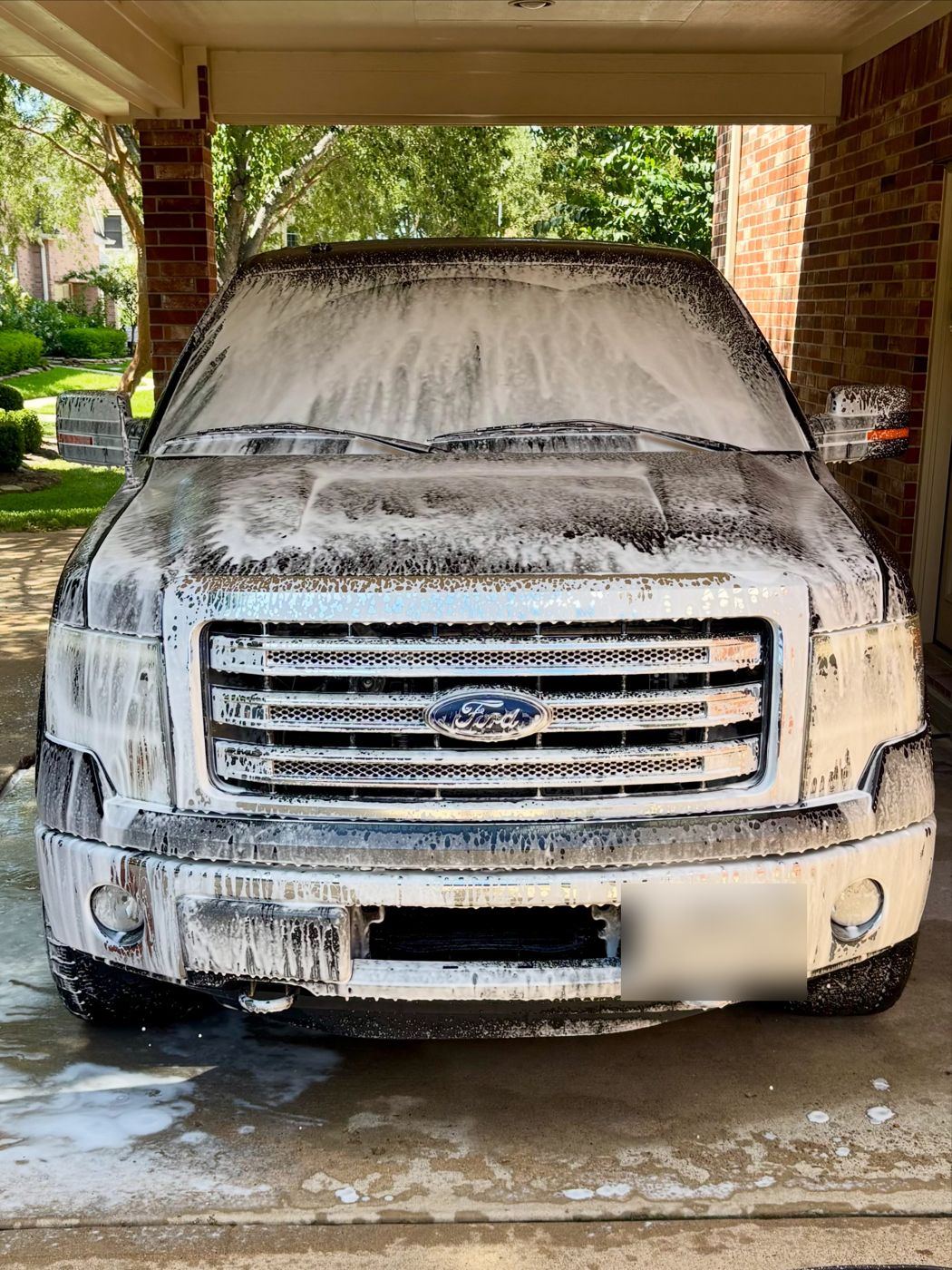 Ford F-150 covered in thick foam during the pre-wash