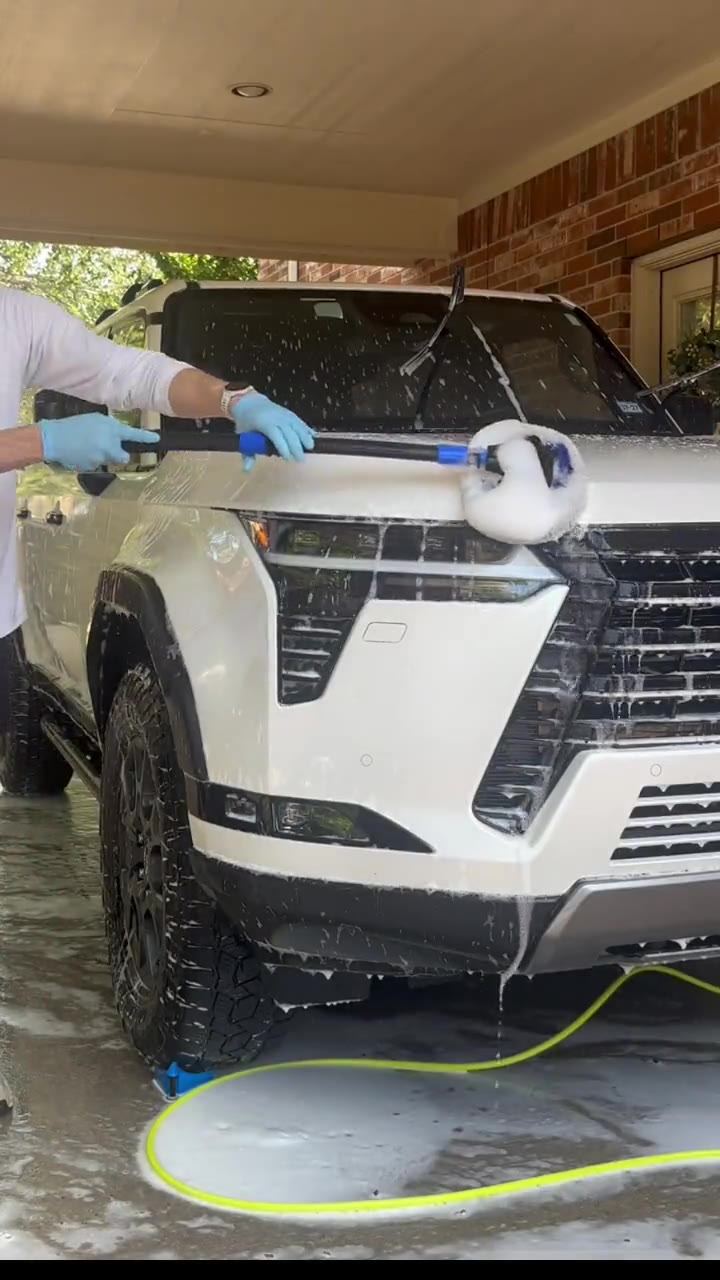Video of a white Lexus GX being foam washed under a carport