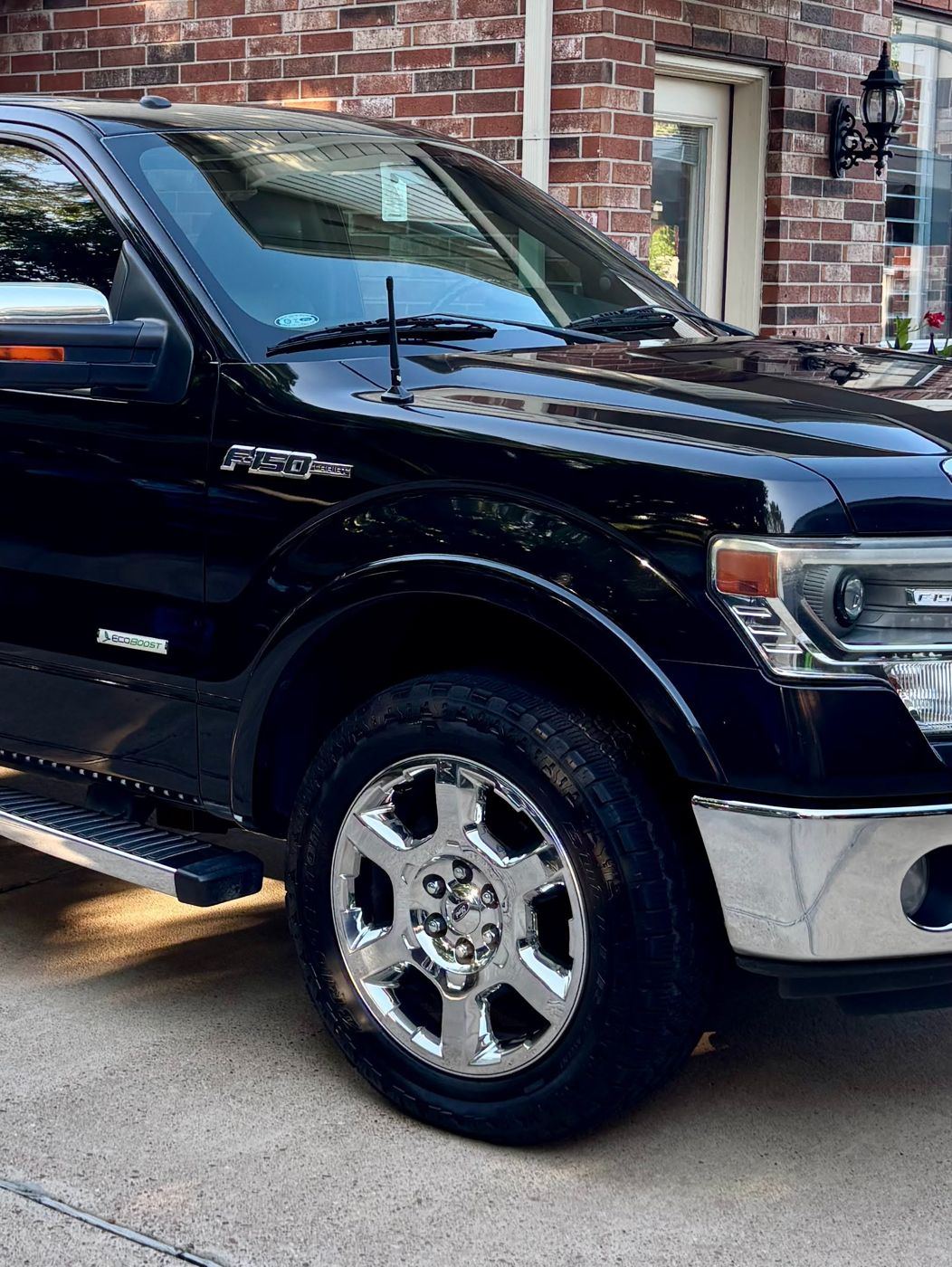 Freshly detailed black Ford F-150 with glossy paint and polished chrome wheels